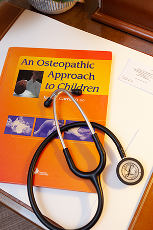 Stethescope and book on paediatrics at 4 Wellington Circus Osteopath practice in Nottingham